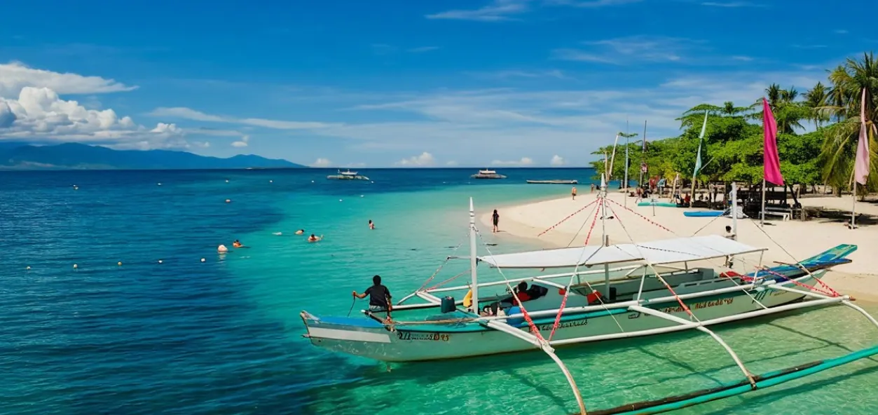 Outrigger boat by a white sand beach